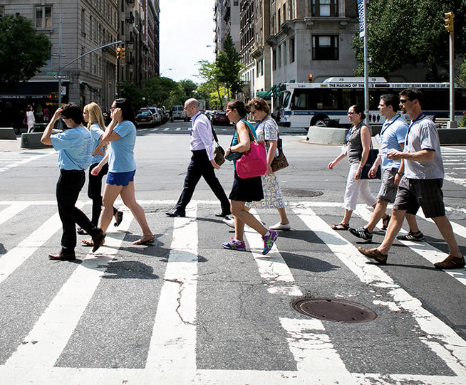 Alumni and their student guides strolled down Broadway during a neighborhood tour. 